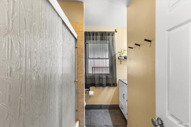 bathroom with tile patterned floors, vanity, and walk in shower