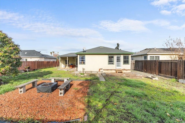 back of property with a patio area and a yard