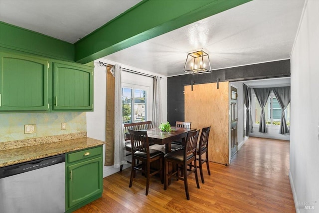 dining room with hardwood / wood-style flooring, a notable chandelier, a healthy amount of sunlight, and crown molding