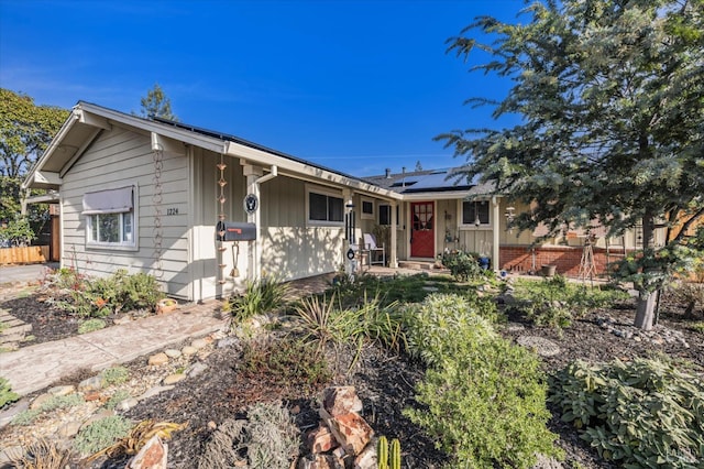 ranch-style house featuring solar panels