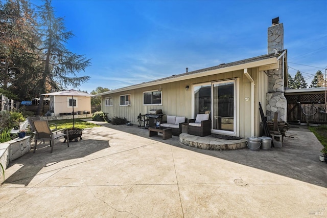 rear view of house featuring outdoor lounge area and a patio