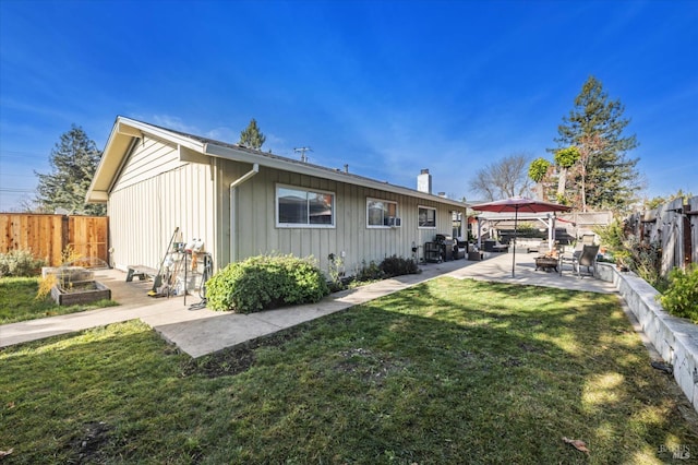 rear view of house with a gazebo, a patio area, and a lawn