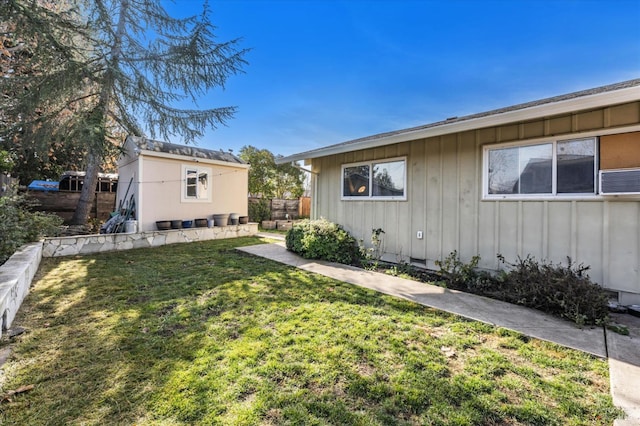 view of side of home with a yard and an outdoor structure