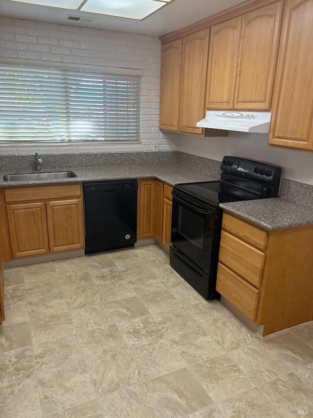 kitchen featuring under cabinet range hood, a sink, visible vents, black appliances, and dark countertops