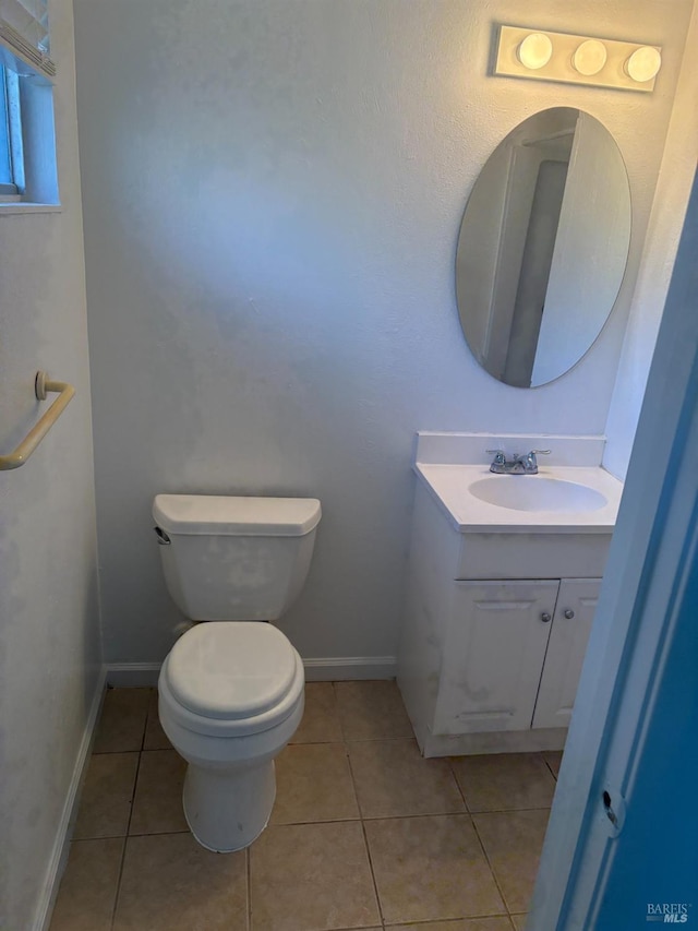 bathroom with tile patterned flooring, vanity, and toilet