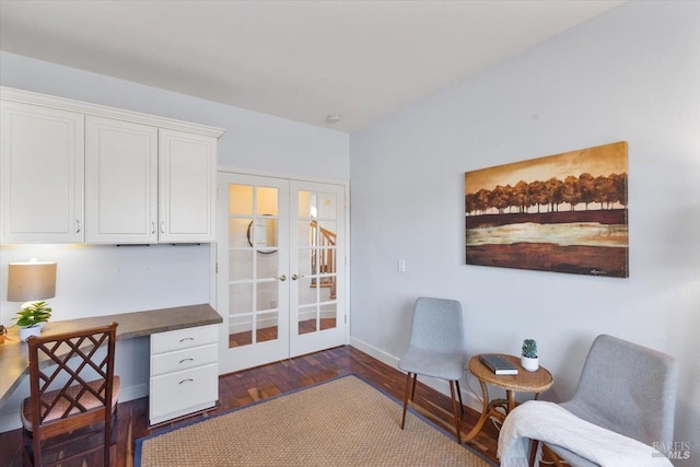 living area with dark wood-type flooring, built in desk, and french doors