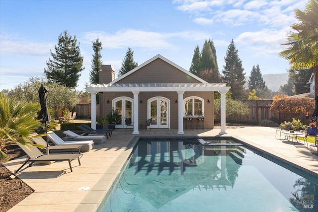 view of pool featuring an outbuilding and a patio area