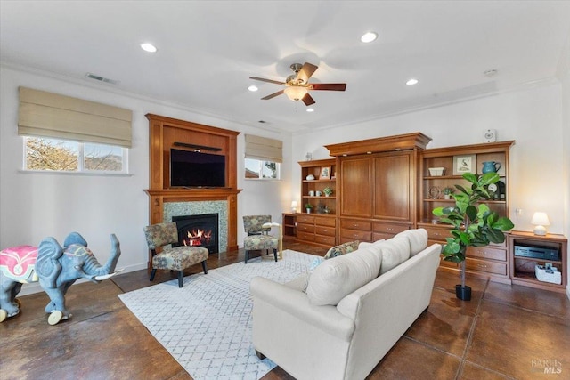 living room with ornamental molding and ceiling fan