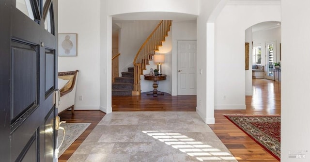 entryway featuring hardwood / wood-style floors and a high ceiling