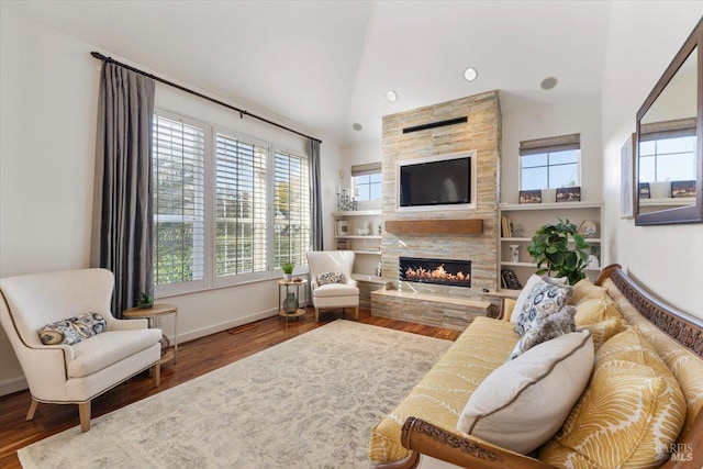 living room featuring hardwood / wood-style flooring, a wealth of natural light, and a fireplace