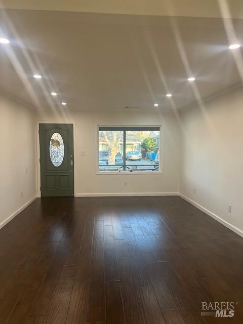 foyer entrance featuring dark hardwood / wood-style flooring and lofted ceiling