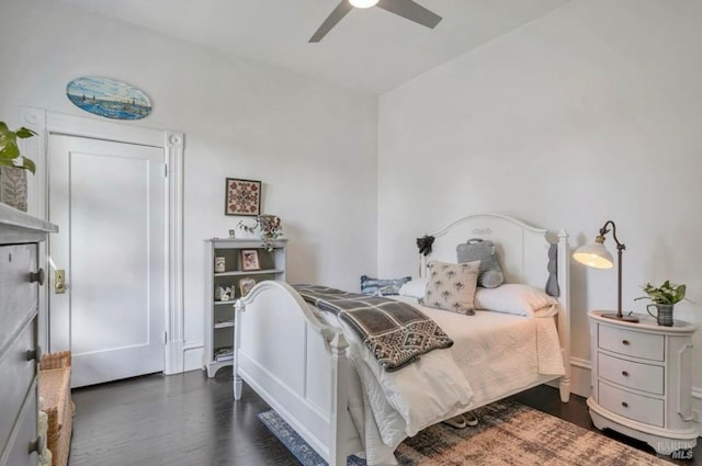 bedroom with dark hardwood / wood-style flooring and ceiling fan