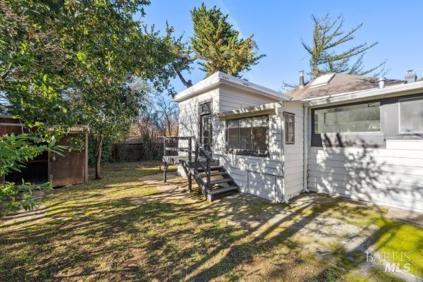 view of property exterior with a lawn