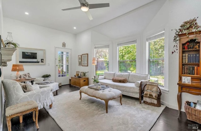 living room featuring vaulted ceiling, ceiling fan, and dark wood-type flooring