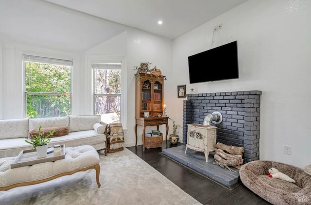 living room with dark hardwood / wood-style floors and a wood stove