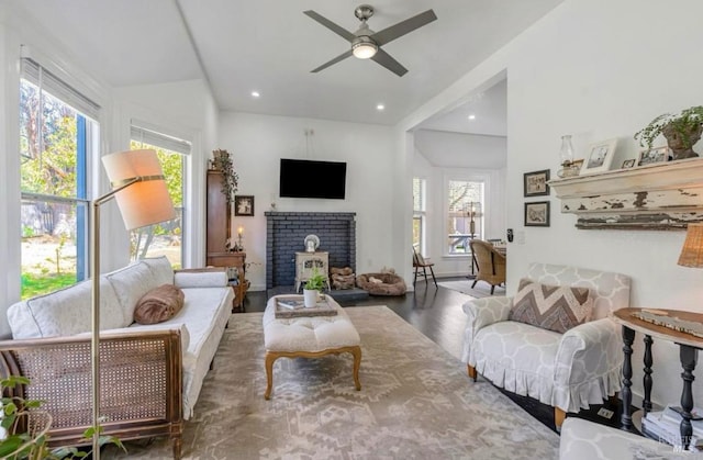 living room with a wealth of natural light, ceiling fan, and wood-type flooring