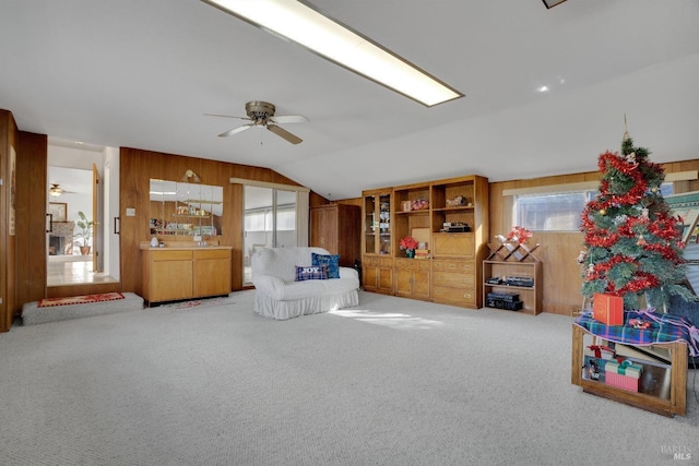 rec room featuring light carpet, lofted ceiling, and wood walls