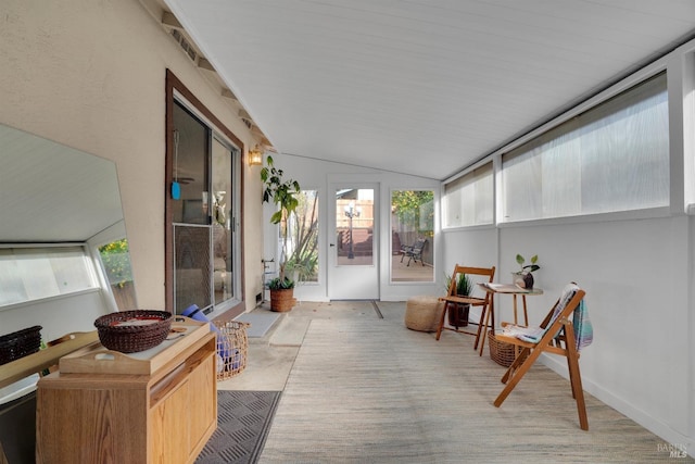 sunroom / solarium featuring vaulted ceiling