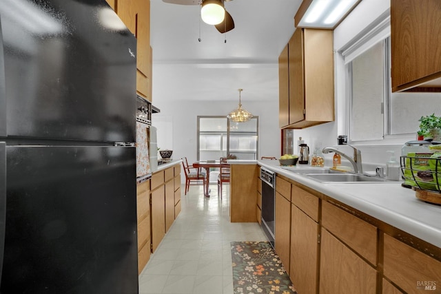 kitchen featuring ceiling fan with notable chandelier, sink, decorative light fixtures, and black appliances