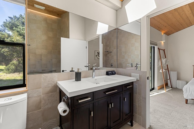 bathroom featuring wooden ceiling, lofted ceiling, toilet, vanity, and tile walls