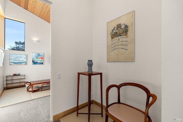 sitting room featuring wood ceiling, carpet floors, and vaulted ceiling