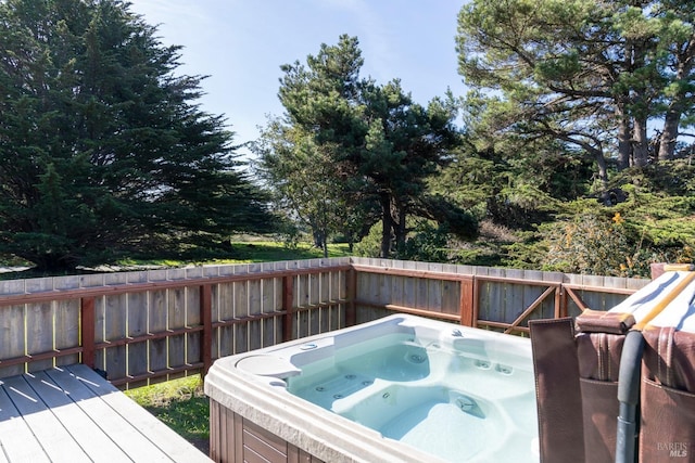 wooden terrace with a hot tub