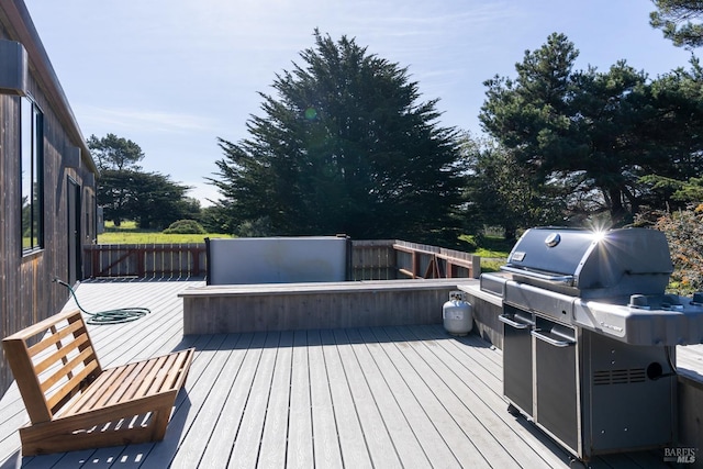 wooden deck with a grill