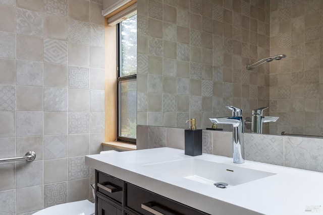 bathroom featuring vanity, toilet, and tile walls