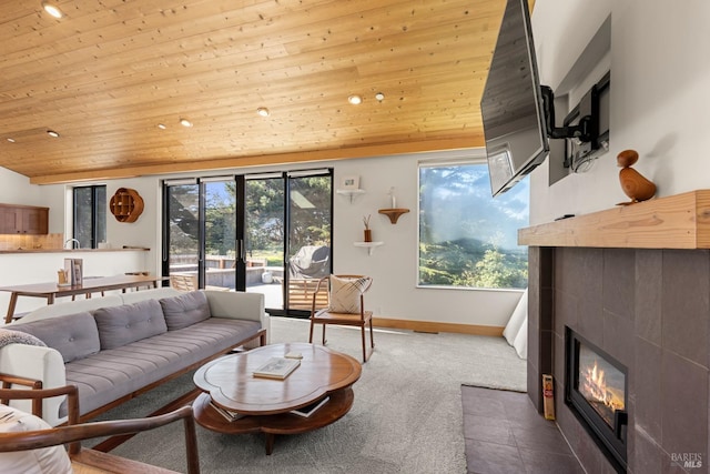 living room featuring plenty of natural light, wooden ceiling, a fireplace, and lofted ceiling