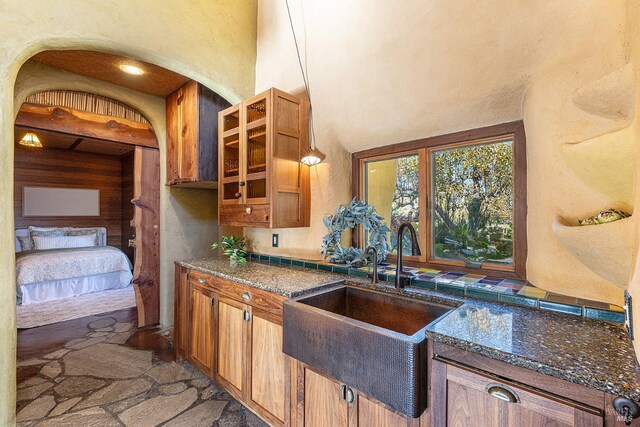 kitchen with sink and dark stone counters