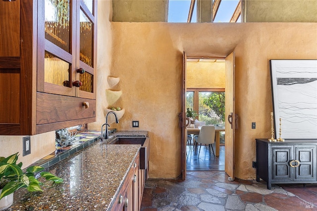 kitchen with dark stone countertops and sink