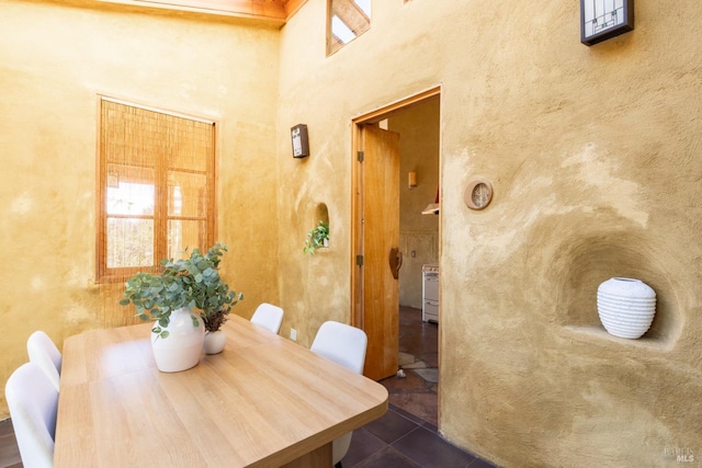 dining room featuring dark tile patterned floors