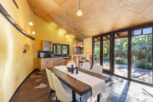 dining room featuring high vaulted ceiling, a wealth of natural light, and french doors