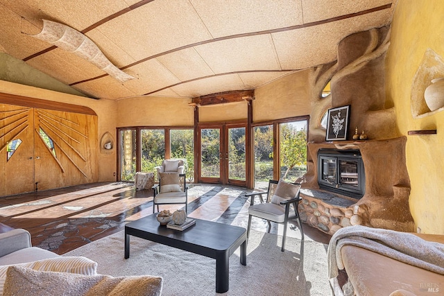 living room featuring a textured ceiling, french doors, and lofted ceiling