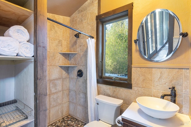 bathroom featuring a shower with shower curtain, vanity, toilet, and tile walls