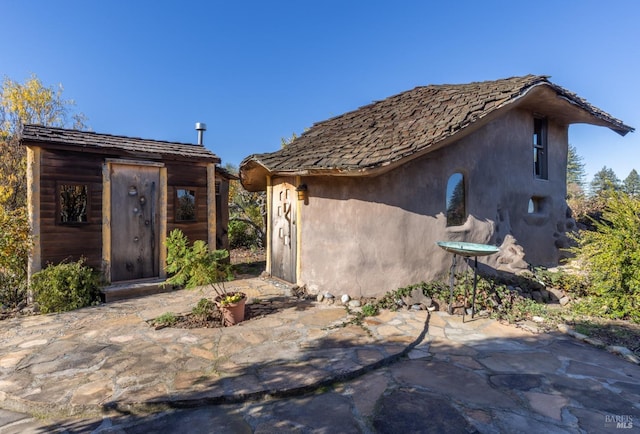 exterior space featuring a patio area and a shed