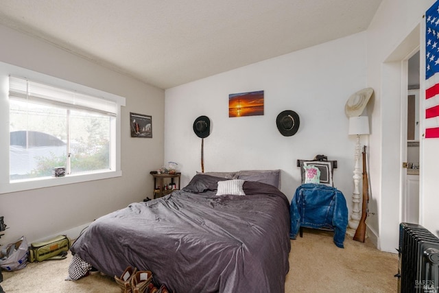 carpeted bedroom featuring radiator heating unit and lofted ceiling