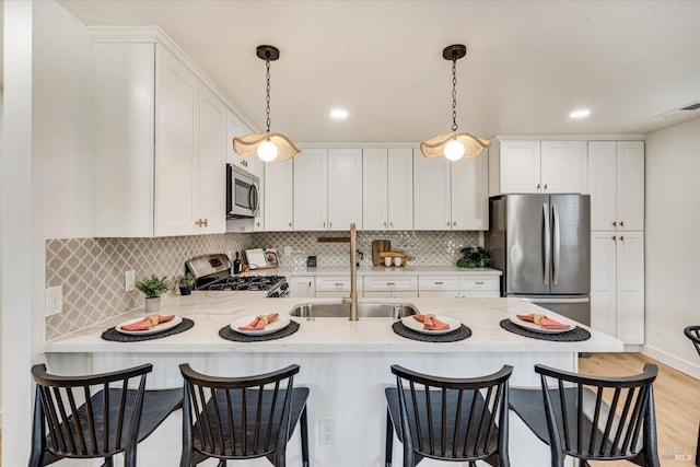 2221 Adrian St, Napa, CA 94558 - kitchen featuring appliances with stainless steel finishes, a sink, a peninsula, white cabinets, and recessed lighting