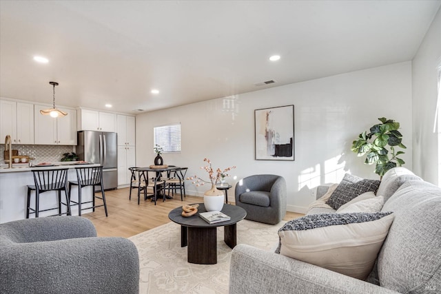 living room with light hardwood / wood-style flooring