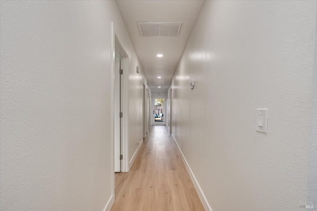 hallway with light wood-type flooring