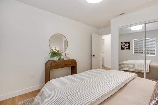 bedroom with a closet and hardwood / wood-style floors