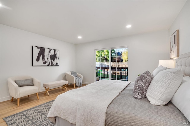 bedroom with access to exterior and wood-type flooring