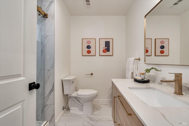 bathroom with vanity, toilet, and a tile shower