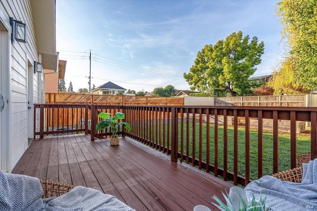 wooden terrace featuring a lawn