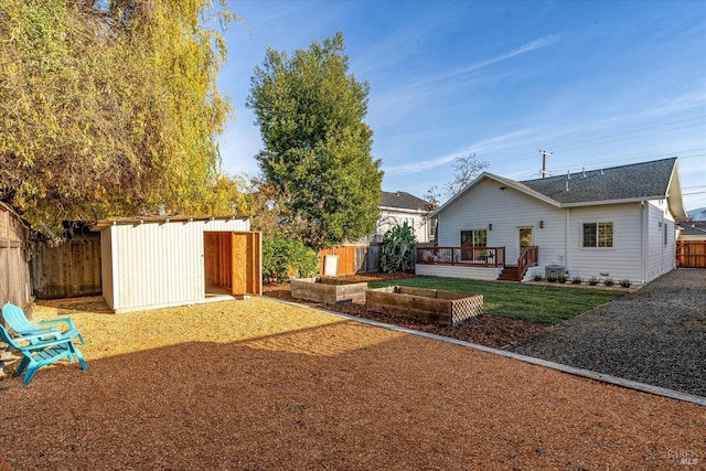 view of yard with a shed and a deck