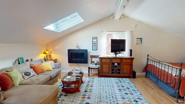 living room with light wood-type flooring and vaulted ceiling with skylight