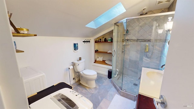 bathroom featuring vanity, toilet, an enclosed shower, and vaulted ceiling with skylight