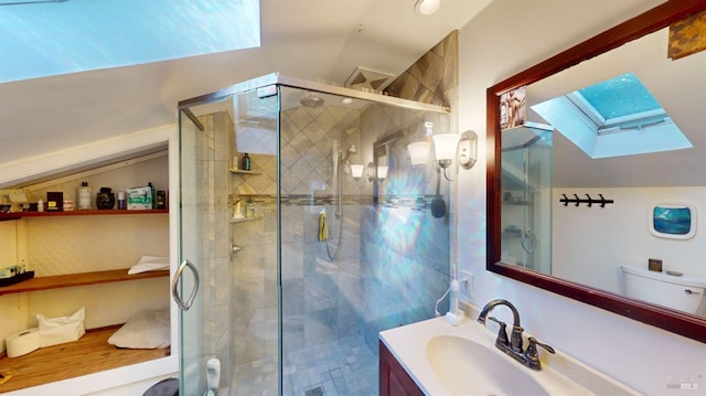 bathroom with vanity, lofted ceiling with skylight, and walk in shower