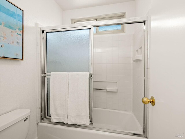 full bathroom with vanity, tile patterned flooring, toilet, enclosed tub / shower combo, and a textured ceiling