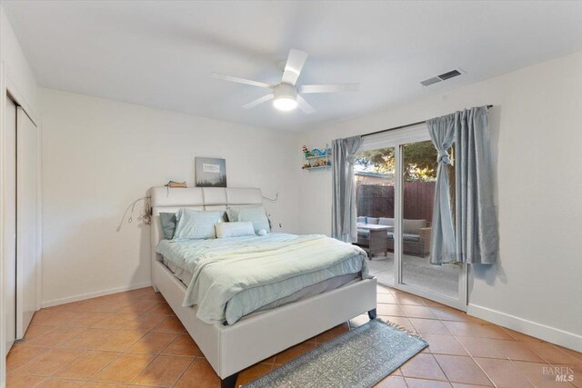 tiled bedroom featuring ceiling fan, access to outside, and a closet